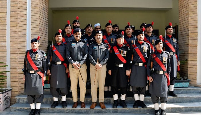 Deputy Inspector General (DIG) of Police Malakand Division Sheer Akbar Khan poses with a group for photo during his visit to Bajaur district on April 10, 2025. — Facebook@malakandregionpolice