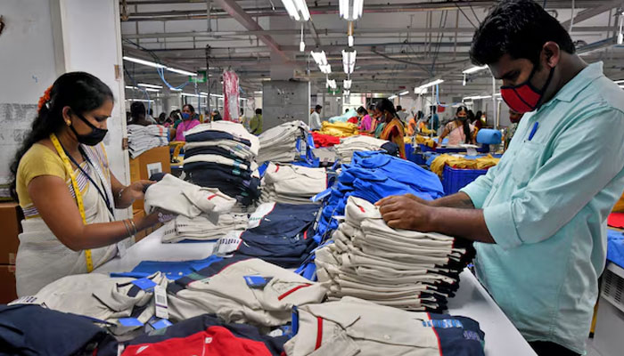 Workers conduct quality checks before packing t-shirts at a textile factory of Texport Industries in Hindupur town in the southern state of Andhra Pradesh, India, February 9, 2022. — Reuters