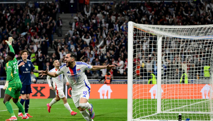 Rayan Cherki (centre) celebrates his late Europa League equaliser for Lyon as United goalkeeper Andre Onana (left) appeals. — AFP