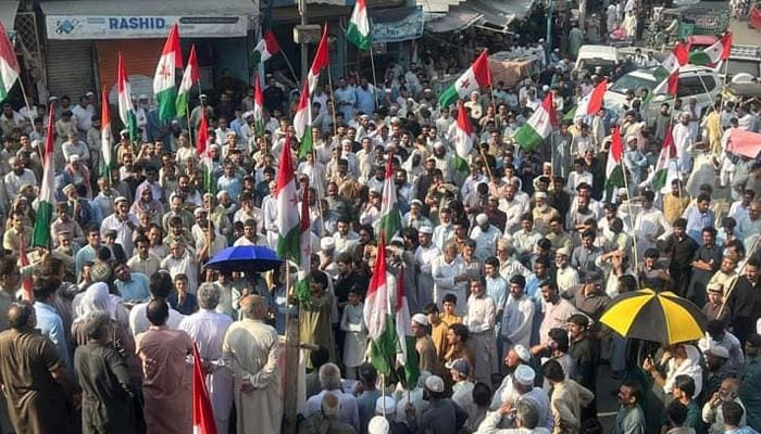 Pakhtunkhwa Milli Awami Party (PkMAP) supporters wave flags at a rally on June 23, 2023. — Facebook@Pakhtunkhwa Milli Awami Party