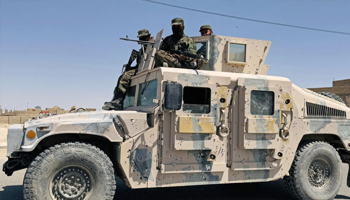Taliban security personnel patrol the city of Zaranj where a man was publicly executed at a football stadium. — AFP/File