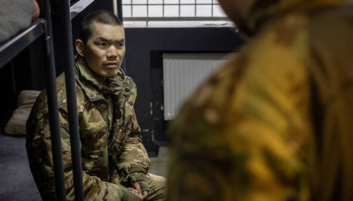 This handout image released by the Security Service of Ukraine (SBU) on April 9, 2025, shows a soldier presented as Chinese detained by Ukrainian authorities at an undisclosed location in Ukraine, following his capture by the Ukrainian army. — AFP
