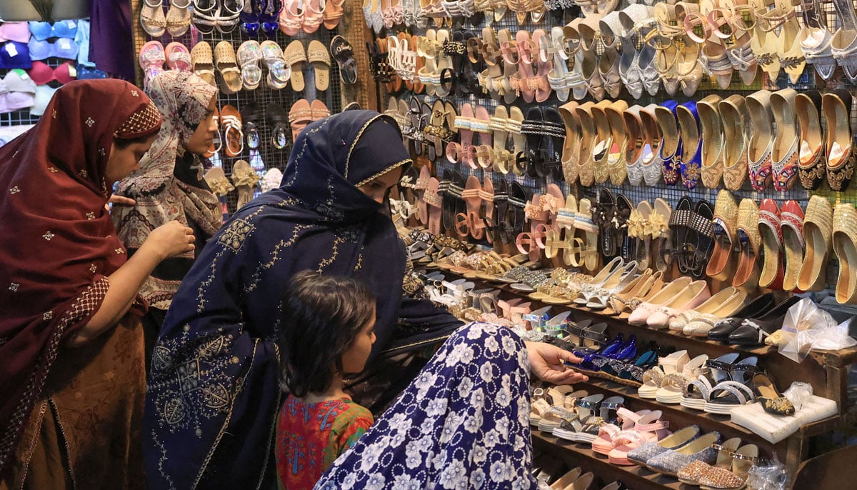 Women and children shop in the market, ahead of Eid in Karachi on March 29, 2025. — Reuters