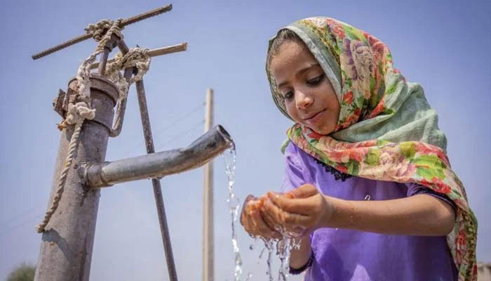 The representational image shows a girl drinking water from a water pump. — Unicef/File
