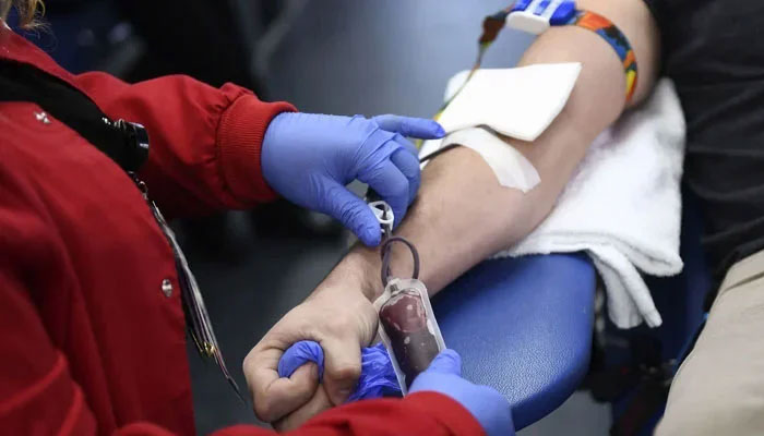 A person donates blood at a blood camp in this image. — AFP/File