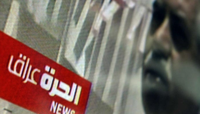 A TV displays the Alhurra Iraq logo in the lobby of the headquarters of the network after its launch in 2004 at its office in Springfield, Virginia. —AFP/File