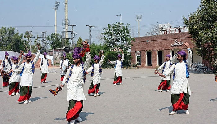 The artists present Jhomar dance on the beat of the drum in relation to the Punjab Culture Day at the Arts Council. — APP/File