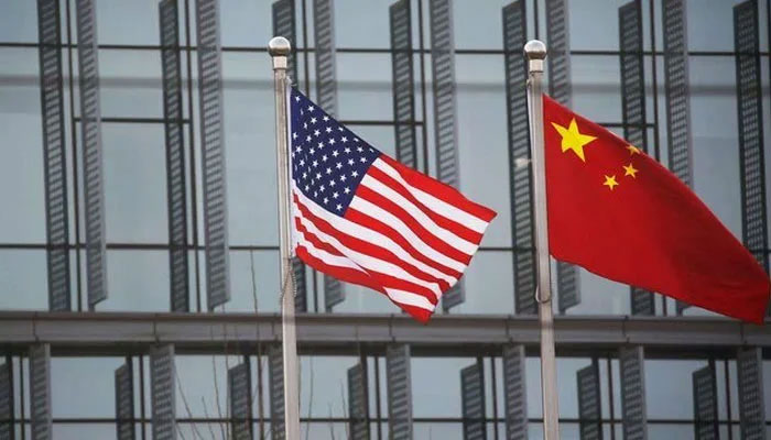 Chinese and US flags flutter outside the building of an American company in Beijing, China, January 21, 2021. — Reuters