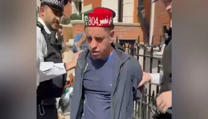 Gulfam Hussain is being taken into custody by police in London. — Screengrab/reporter