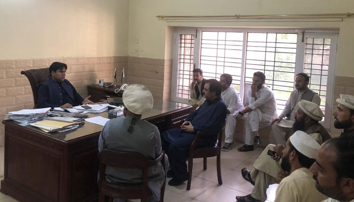 Tehsil chairman Nawabzada Hassam (centre)  along with locals meets FIA offical regarding child pornographic videos on April 17, 2025. — Facebook@Hassan Saeed