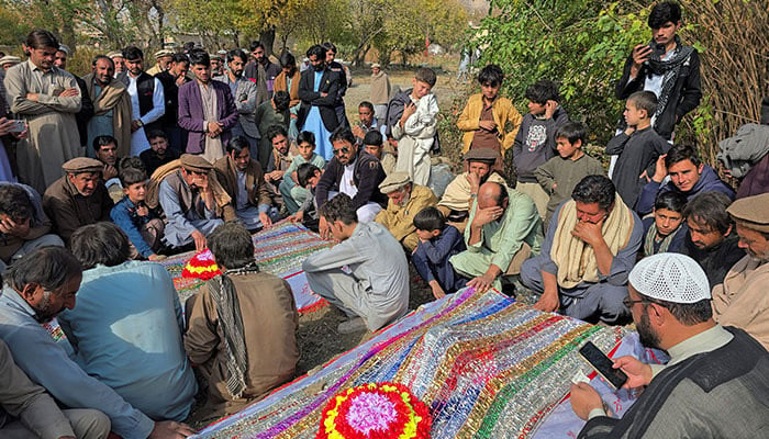 People mourn over the graves of relatives in KP on November 22, 2024. — Reuters