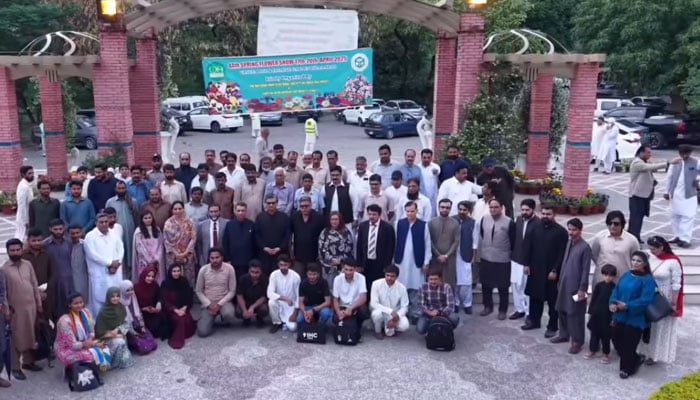 People pose for a group photo at the spring flower show at the Islamabad Rose and Jasmine Garden on April 19, 2025. — Screengrab via Facebook@cda.isb.pk