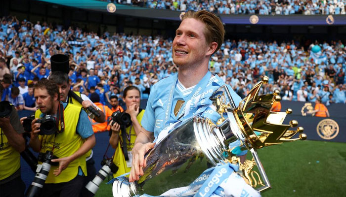 Manchester Citys Kevin De Bruyne celebrates with the trophy after winning the Premier League. —Reuters/File
