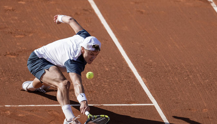 Holger Rune playing a shot against Carlos Alcaraz on Sunday in the Barcelona Open final. —AFP/File