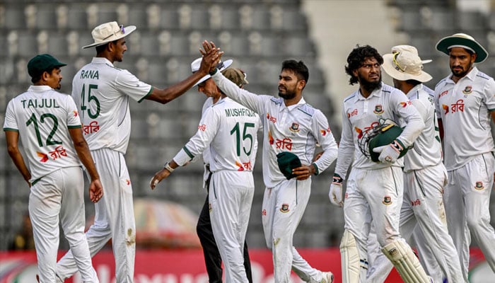 Bangladesh’s Mehidy Hasan Miraz (centr) celebrates after taking the wicket of Zimbabwe’s Victor Nyauchi. —AFP/File