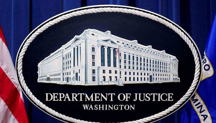A US Justice Department logo or seal showing Justice Department headquarters, known as Main Justice, is seen behind the podium in the Departments headquarters briefing room, January 24, 2023. —Reuters