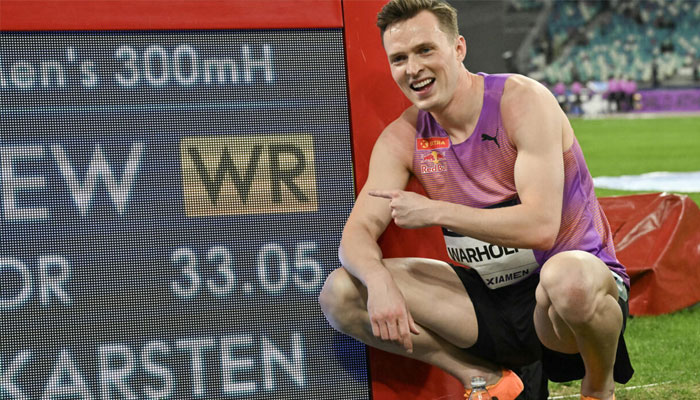 Norways Karsten Warholm poses with his time of 33.05 seconds after he broke the mens 300m hurdles world record during the Xiamen IAAF Diamond League athletics meeting at Egret Stadium in Xiamen, in China’s eastern Fujian province, on April 26, 2025. — AFP