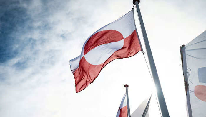 Greenlands flag flutters at the Inussivik hall in Nuuk, Greenland, April 6, 2021. — Reuters