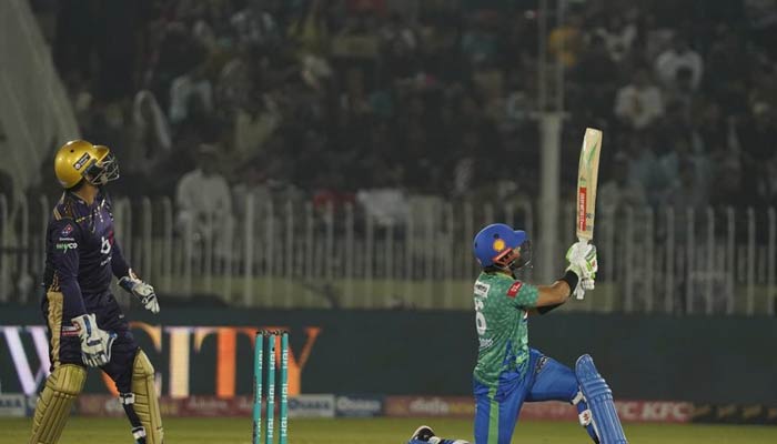 Multan Sultan batter hits a shot as the Quetta Gladiators wicketkeeper looks on during the 28th match of the ongoing season of the Pakistan Super League (PSL) at the Pindi Cricket Stadium on March 11, 2023. — PSL