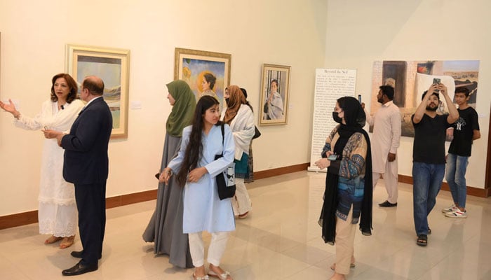 Visitors view the A Moment in Time painting exhibition at the National Art Gallery, organized by ForArtSake and the Pakistan National Council of the Arts (PNCA) on April 28, 2025. — APP