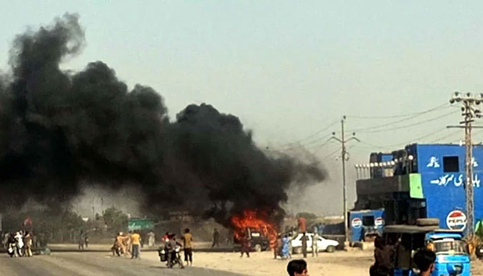 View of smoke rising from a police vehicle torched during the protest demonstration of political parties, legal fraternity and civil society against building new canals at Gulshan-e-Hadeed in Karachi on April 27, 2025. — PPI