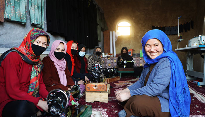 Afghan women in a stitching centre posing for photo. —UNDP/File