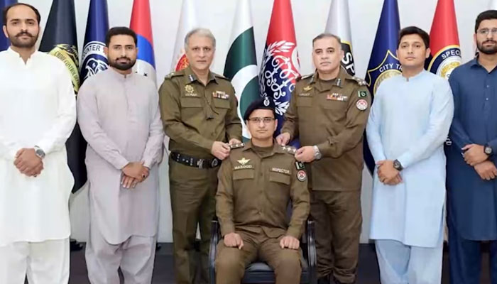IG Punjab Dr Usman Anwar (centre left) and senior officer pin promotion rank on a promoted officer on May 1, 2025. — Facebook@PunjabPolicePakistanOfficial