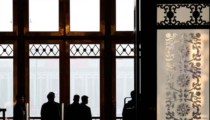 Security personnel keep watch at the second plenary session of the National Peoples Congress (NPC), at the Great Hall of the People in Beijing, China March 8, 2025.—Reuters