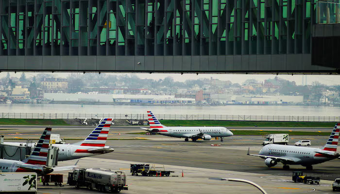 Planes are seen on the tarmac as travelers walk inside LaGuardia airport in New York City, U.S., April 6, 2023. — Reuters