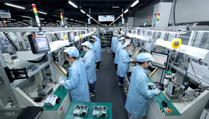 Workers work on a production line at a factory in Suqian, Jiangsu Province, China April 9, 2025. —Reuters
