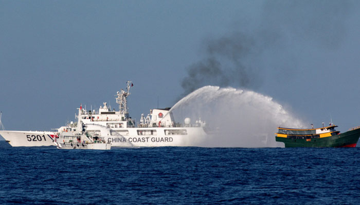 Chinese Coast Guard vessels fire water cannons towards a Philippine resupply vessel Unaizah May 4 on its way to a resupply mission at Second Thomas Shoal in the South China Sea, March 5, 2024.—Reuters