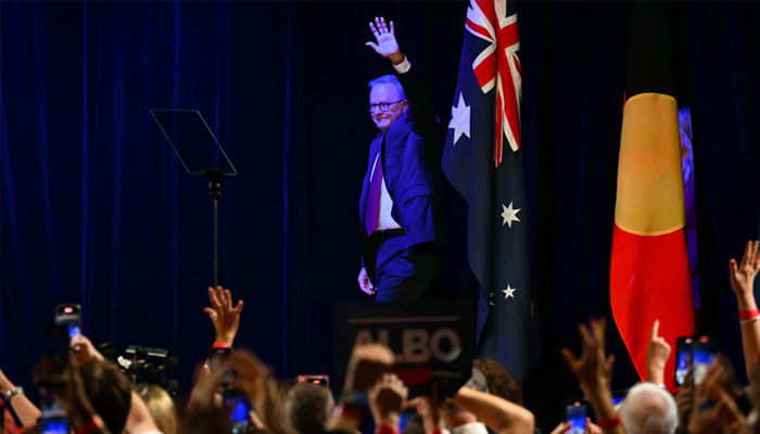 Australias Prime Minister Anthony Albanese waves as he arrives onstage in Sydney after winning a general election. —AFP/File