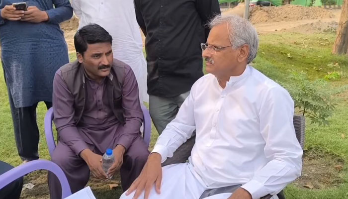 Wasa Managing Director Ghufran Ahmed (right) is being briefed about the ongoing project of replacing the trunk sewer on Khayaban Ferdowsi in Johar Town on May 4, 2025. — Screengrab via Facebook@lahorewasa