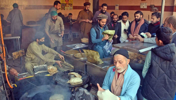 Representational image shows people buy the traditional breakfast item “ Halwa Pori” from a shop in Rawalpindi on February 2, 2025. — Online