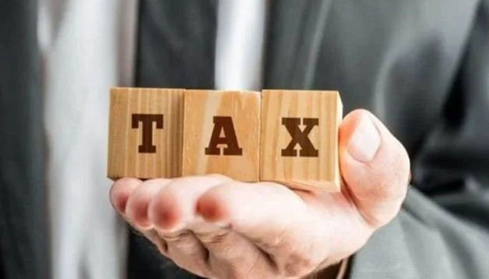 A representational image of tax shows wooden boxes with letters T, A and X written on them. — Reuters/File