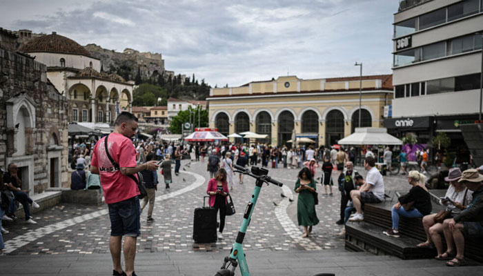 An electric scooter that has been left on a pedestrian street under the the Athens Acropolis hill, on May 5, 2025. —AFP