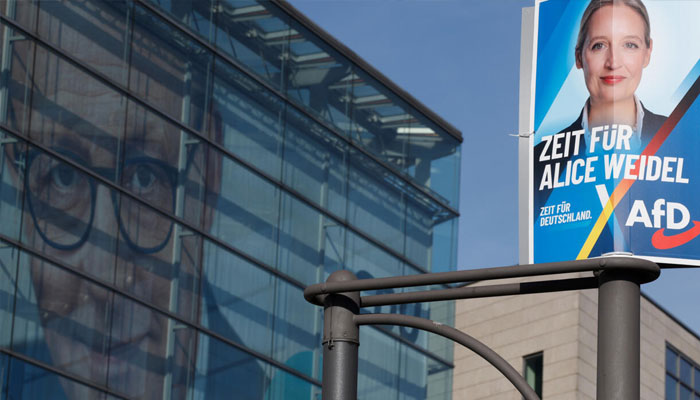 An election poster of candidate and co-leader of Germanys far-right Alternative for Germany (AfD) party Alice Weidel is seen in front of the headquarters of the Christian Democratic CDU party with a picture of the CDUs candidate and leader Friedrich Merz on its facade, Berlin, February 24, 2025. —AFP