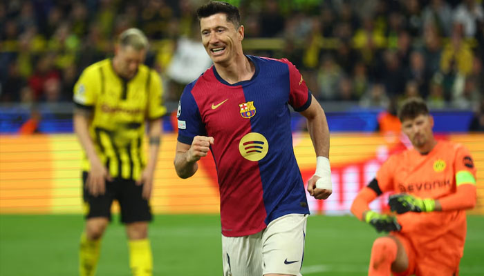 FC Barcelonas Robert Lewandowski celebrates their first goal, an own goal scored by Borussia Dortmunds Ramy Bensebaini. —AFP/File