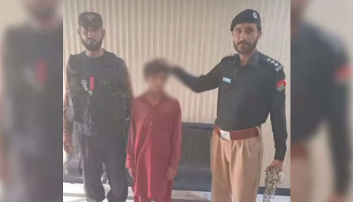Police personnel pictured with extricated boy in this image released on May 7, 2025. — Screengrab via Facebook@RPO BANNU