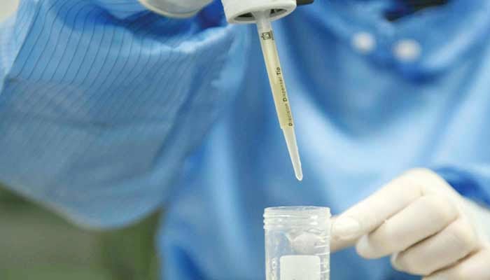 A health worker pouring a sample in testtube. —TheNews/File