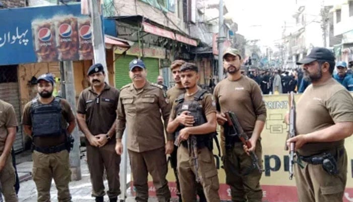Punjab police personnel standing guard on the road on August 26, 2024. — Facebook@PunjabPolicePakistanOfficial