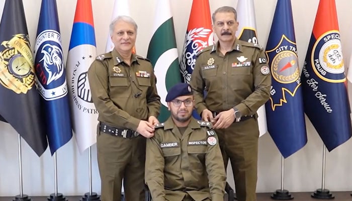 IG Punjab Dr Usman Anwar (centre left) and senior officer pin promotion rank on a promoted officer on May 8, 2025. — Facebook@PunjabPolicePakistanOfficial