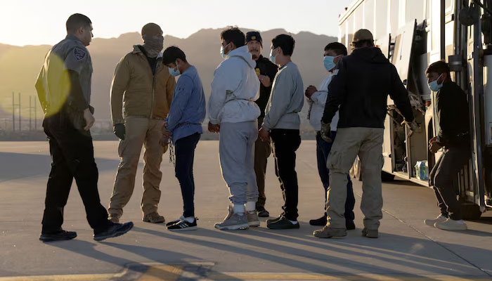 The representational image showing US Customs and Border Protection security agents guide detained migrants to board a U.S. Air Force C-17 Globemaster III aircraft for a removal flight at Fort Bliss, Texas, US January 23, 2025. — Reuters