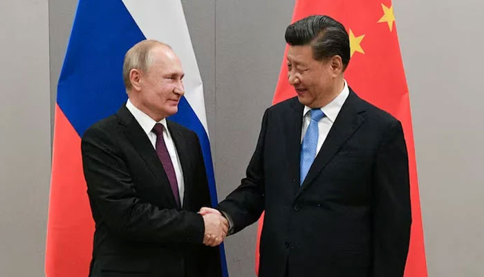 Russian President Vladimir Putin shakes hands with Chinese President Xi Jinping during their meeting on the sidelines of a BRICS summit, in Brasilia, Brazil, November 13, 2019 — Reuters