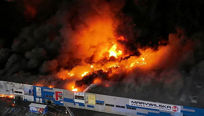 Drone view of the Marywilska 44 shopping centre burning during a massive fire in Warsaw, Poland, May 12, 2024.—Reuters