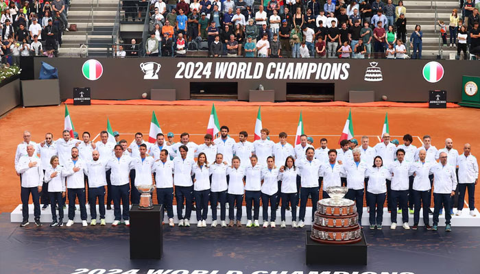 Italys Jannik Sinner celebrates with teammates during a ceremony after Italy won the Davis Cup and Billie Jean King Cup in 2024. —Reuters