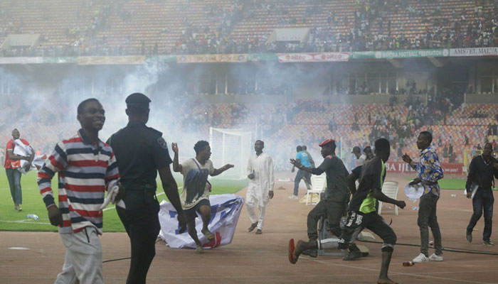 Police fire tear gas to try to remove spectators from the pitch at the Moshood Abiola Stadium in Abuja, Nigeria. —AFP/File
