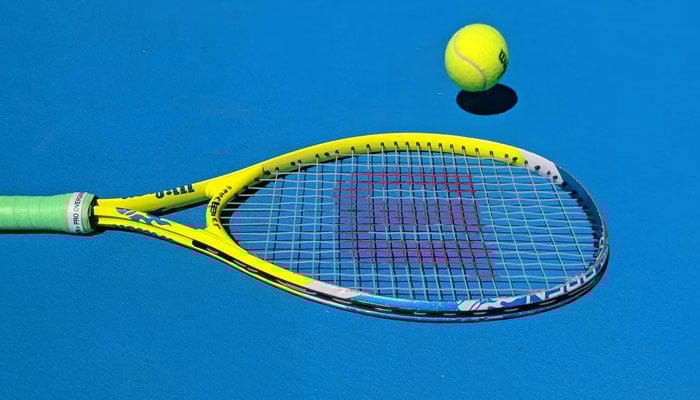 This representational image shows a tennis racket and a ball in the background. — Unsplash/File