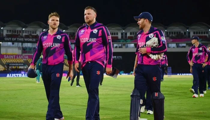 Scotlands Mark Watt and Matthew Cross (right) walk off the field after losing ICC Mens T20 World Cup match against Australia in Gros Islet on June 15, 2024. — ICC