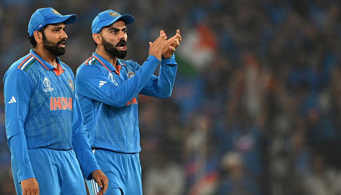 Indias captain Rohit Sharma (left) and teammate Virat Kohli celebrate after the dismissal of Australias Mitchell Marsh at the Narendra Modi Stadium in Ahmedabad on November 19, 2023. —AFP/File